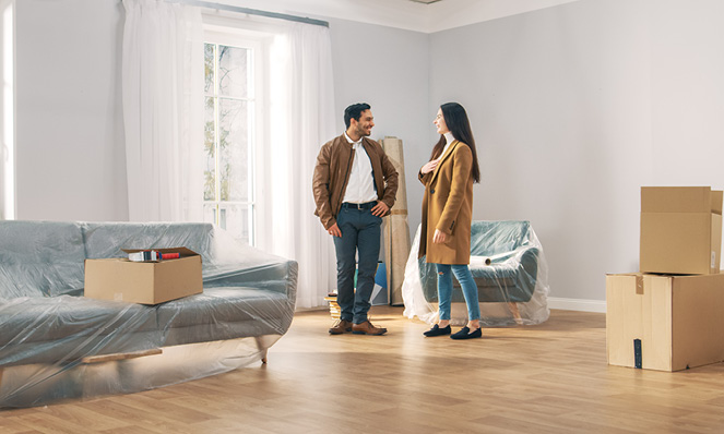 happy-millennial-couple-new-house-unpacking-belongings