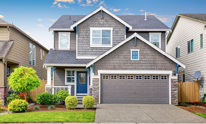 grey-and-blue-house-with--short-driveway-green-shrubery