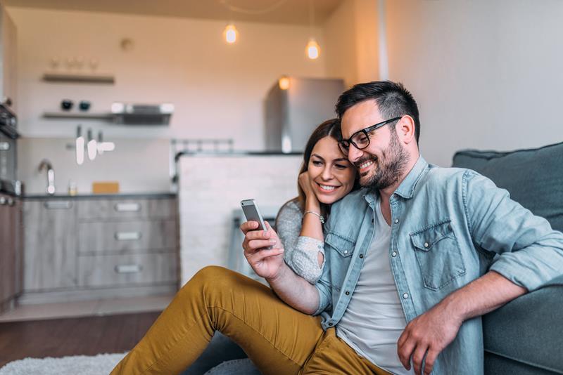 excited-hipster-couple-looking-at-phone