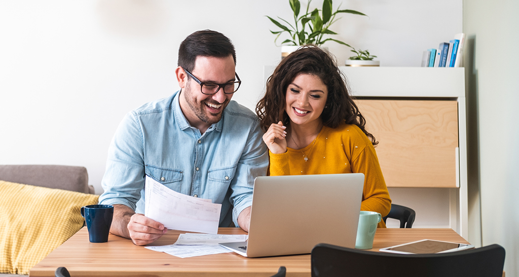 A young couple applying for a mortgage loan after learning about the 5 Cs of Homebuying