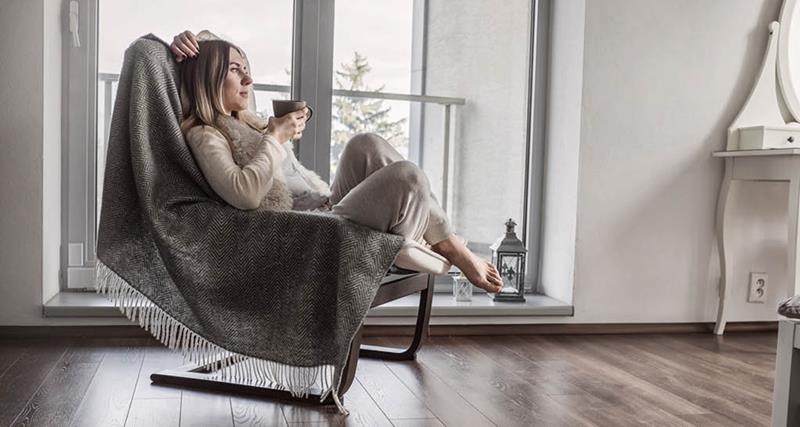 woman-sitting-in-comfy-chair-with-mug
